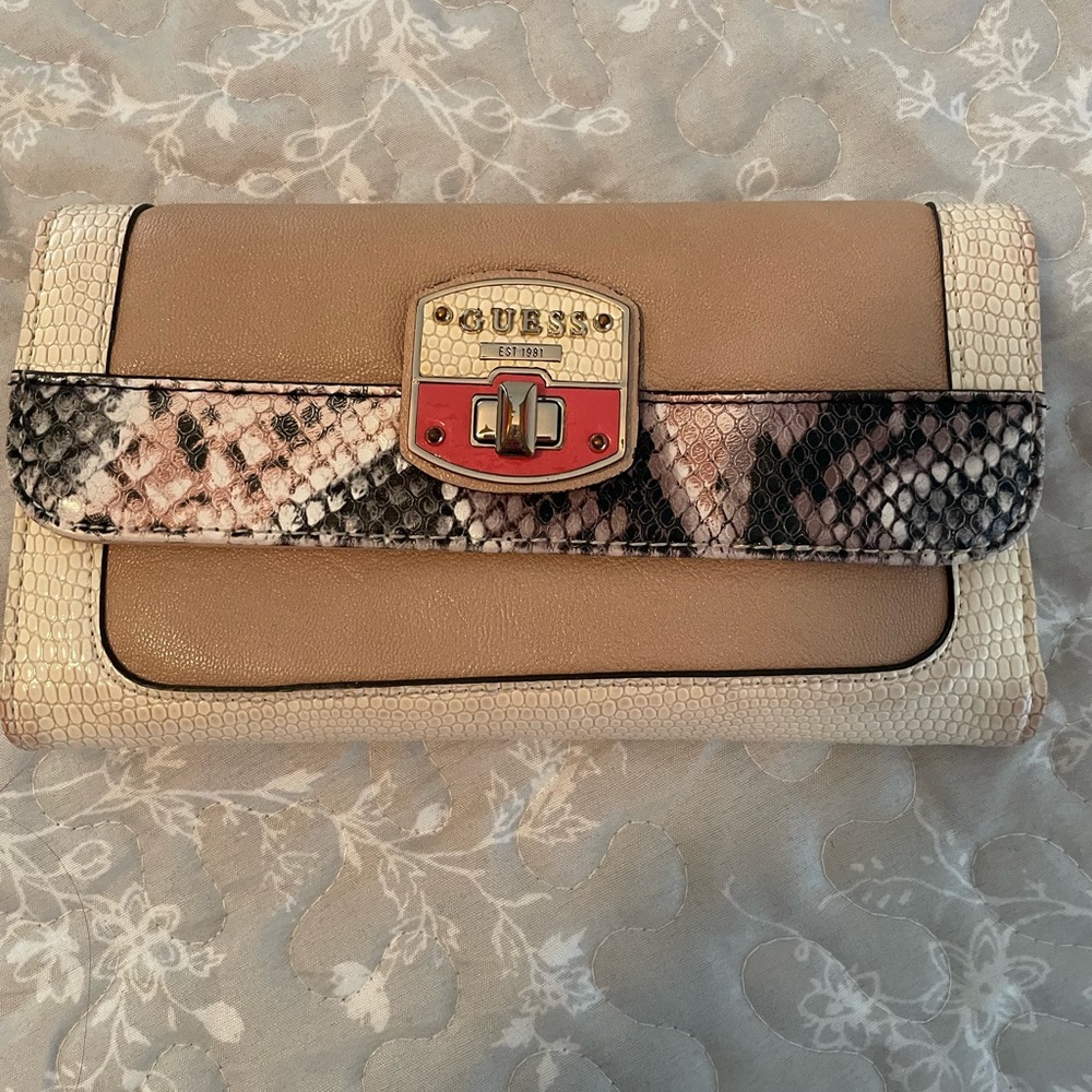 Guess trifold wallet in cream/tan color with faux snake skin design.